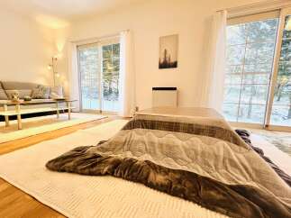 This cozy living space features a traditional kotatsu table, perfect for relaxing and enjoying the warmth.