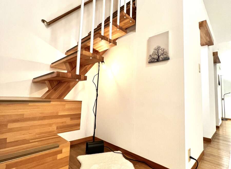 This stunning property features a beautifully crafted wooden staircase, adding a touch of elegance to the interior.