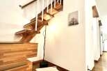 This stunning property features a beautifully crafted wooden staircase, adding a touch of elegance to the interior.