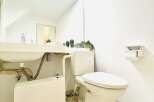 This modern bathroom features a sleek design with a clean, white aesthetic.