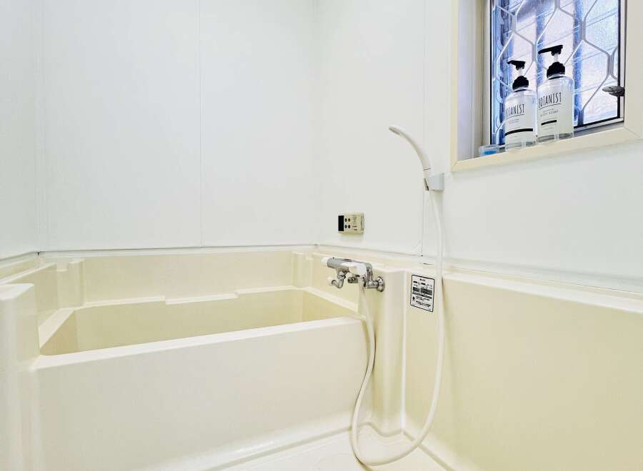 This pristine bathroom offers a clean and modern aesthetic, perfect for relaxation.
