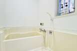 This pristine bathroom offers a clean and modern aesthetic, perfect for relaxation.