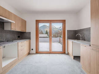 This stunning kitchen boasts modern design and breathtaking mountain views.