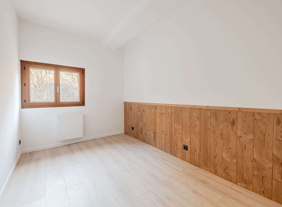 Discover the charm of this inviting room, featuring a beautiful wooden accent wall that adds warmth and character.