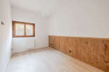 Discover the charm of this inviting room, featuring a beautiful wooden accent wall that adds warmth and character.