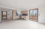 Discover this stunning property featuring a modern kitchen with sleek cabinetry and a stainless steel range hood.