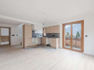 Discover this stunning property featuring a modern kitchen with sleek cabinetry and a stainless steel range hood.