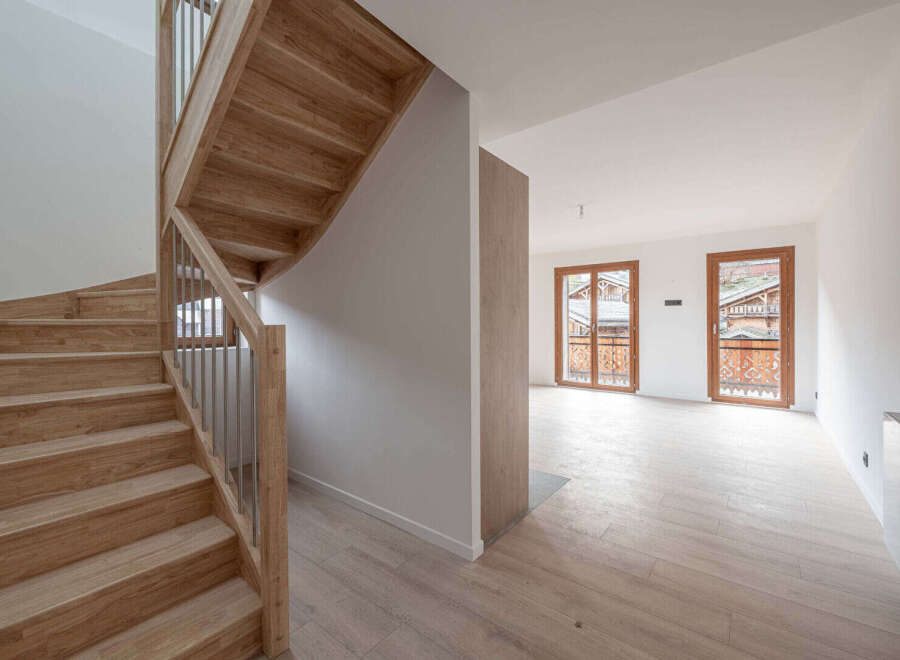 This stunning property boasts a beautiful wooden staircase, adding a touch of elegance to the interior.
