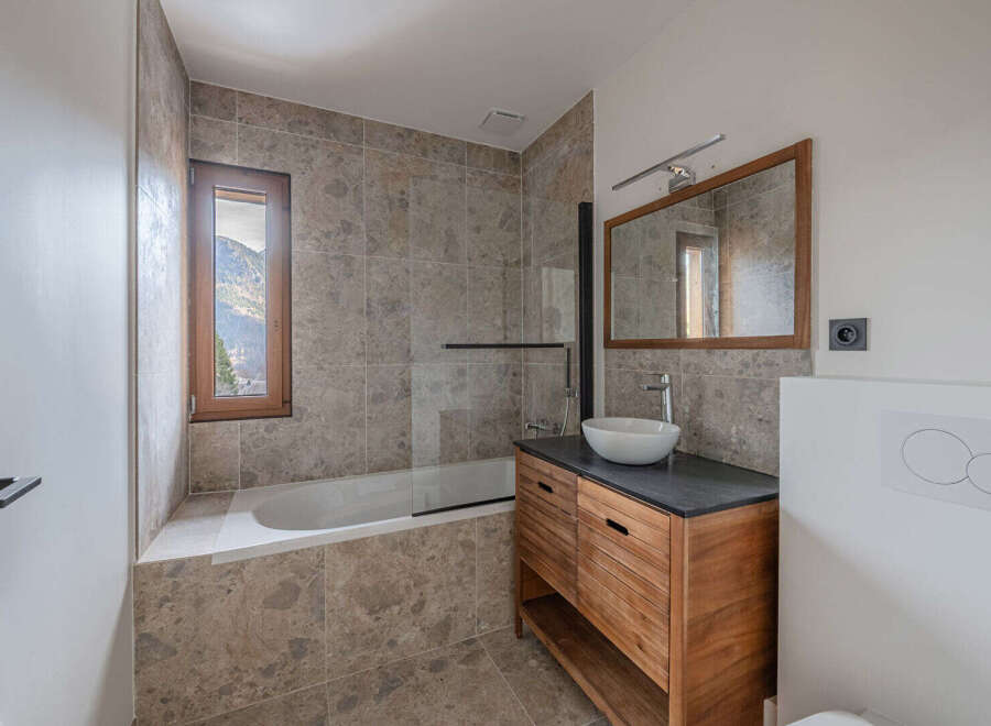 This stunning bathroom features a modern design with a touch of rustic charm.