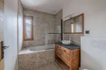 This stunning bathroom features a modern design with a touch of rustic charm.