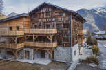 Discover the charm of this stunning wooden chalet nestled in a picturesque mountain setting.