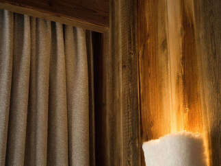 This cozy space features beautiful wooden walls and ceiling, creating a warm and inviting atmosphere.