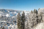 Nestled in a picturesque winter wonderland, this property offers stunning views of snow-capped mountains and a charming village.