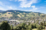 Discover this stunning alpine village nestled amidst rolling green hills and majestic mountains.