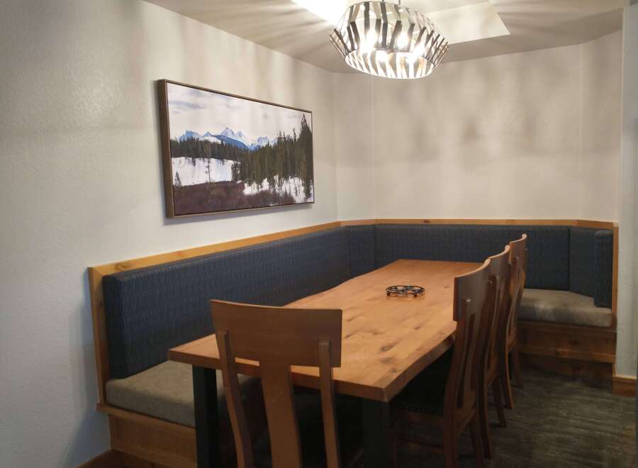 This dining area features a cozy built-in bench, perfect for family gatherings.