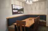 This dining area features a cozy built-in bench, perfect for family gatherings.
