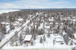 This stunning property offers a serene winter wonderland setting, perfect for those seeking a peaceful retreat.