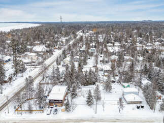 This stunning property offers a serene winter wonderland setting, perfect for those seeking a peaceful retreat.