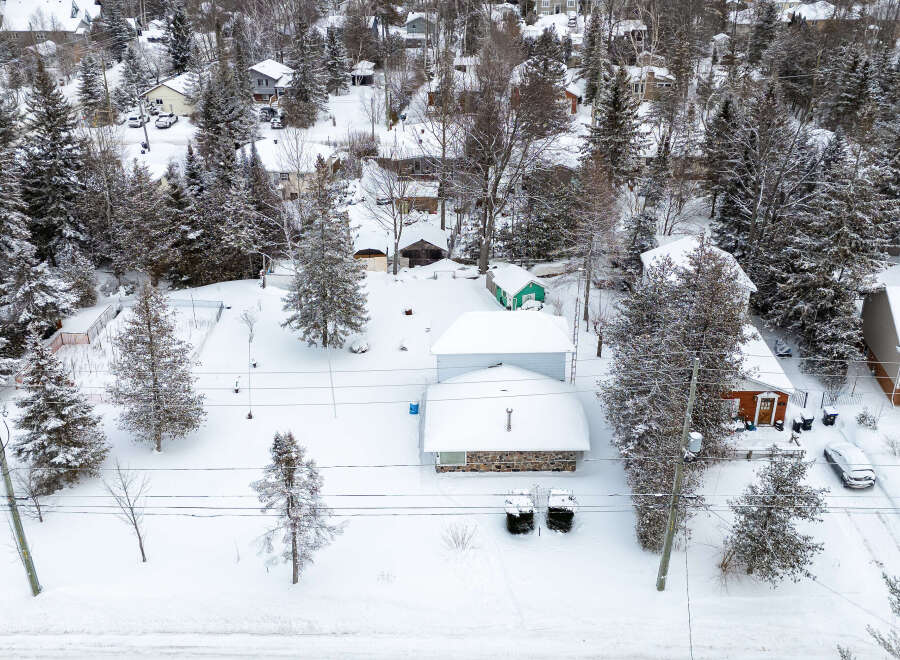 Nestled in a serene winter wonderland, this property boasts a charming, snow-covered exterior.