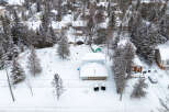 Nestled in a serene winter wonderland, this property boasts a charming, snow-covered exterior.