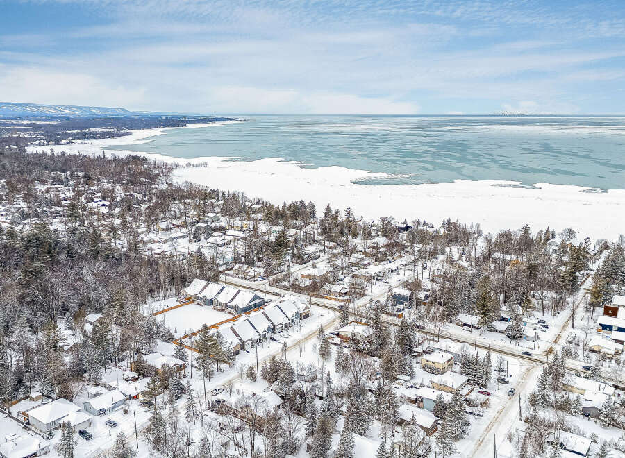 Discover a charming winter wonderland with this stunning property! Nestled in a picturesque neighborhood, this home offers breathtaking views of a snow-covered landscape and a serene lake.