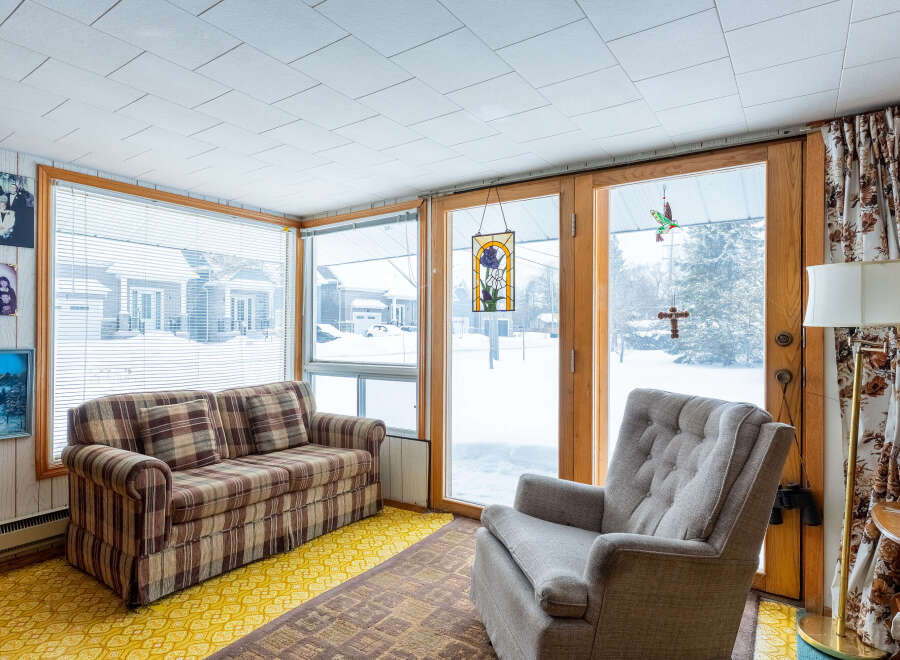 This cozy sunroom offers a warm and inviting space to relax and enjoy the views.