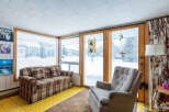 This cozy sunroom offers a warm and inviting space to relax and enjoy the views.