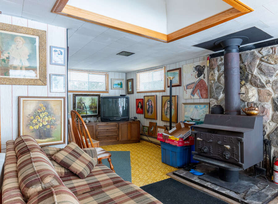 This cozy living space features a charming wood-burning stove, perfect for those chilly evenings.