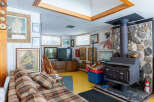 This cozy living space features a charming wood-burning stove, perfect for those chilly evenings.