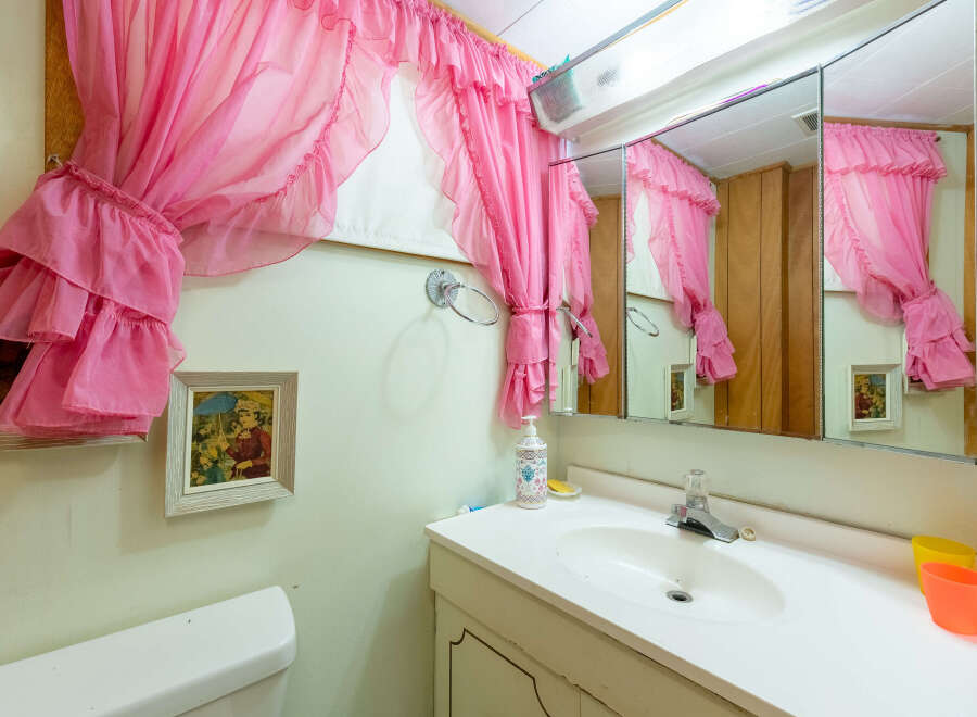Step into this charming bathroom, featuring a unique vintage aesthetic.