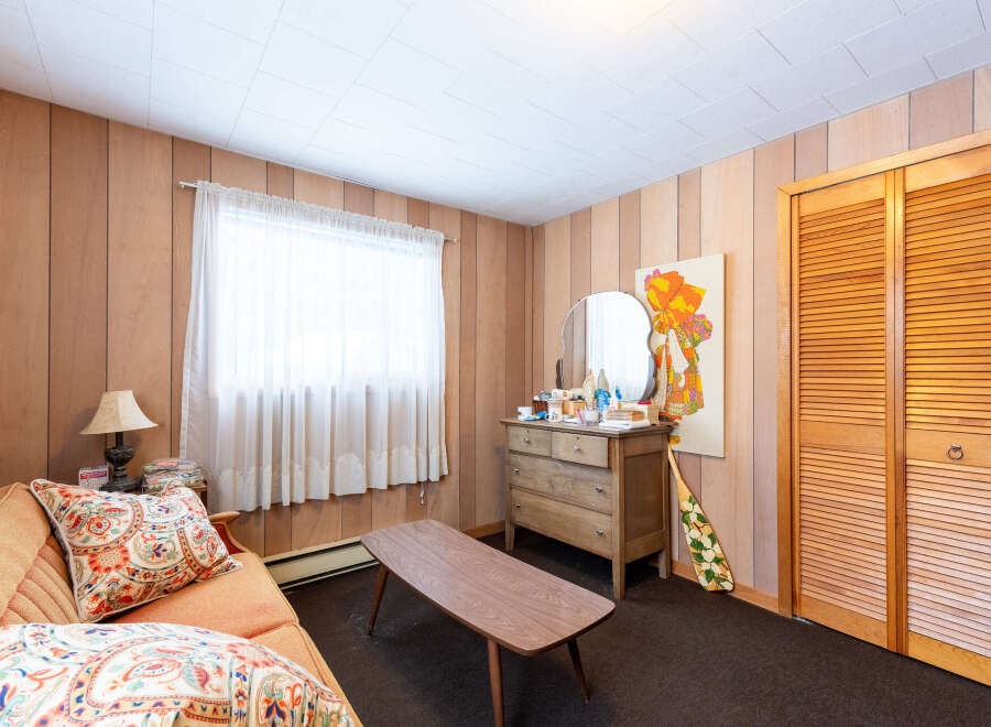 Step into this charming space, featuring a cozy sofa adorned with patterned pillows.