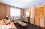 Step into this charming space, featuring a cozy sofa adorned with patterned pillows.