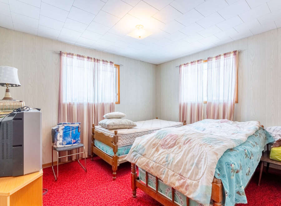 Step into this cozy bedroom featuring two beds, perfect for accommodating guests or creating a comfortable living space.