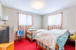 Step into this cozy bedroom featuring two beds, perfect for accommodating guests or creating a comfortable living space.