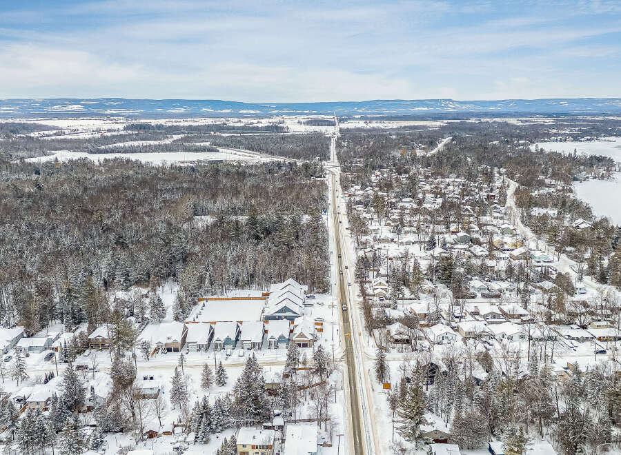 This stunning aerial view showcases a picturesque winter landscape, perfect for those seeking a tranquil retreat.
