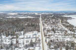 This stunning aerial view showcases a picturesque winter landscape, perfect for those seeking a tranquil retreat.