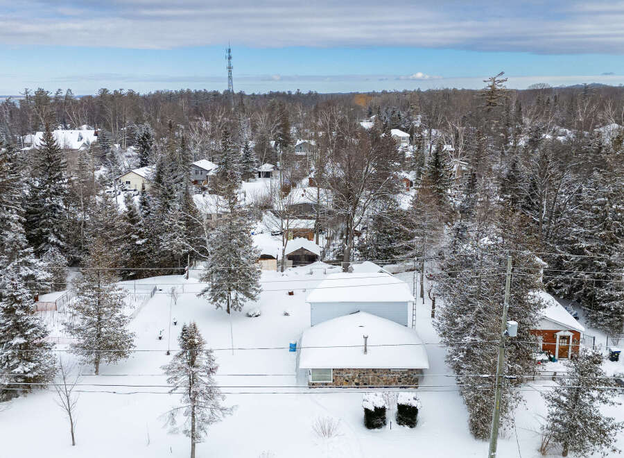 Nestled in a serene winter wonderland, this charming property offers a cozy retreat.