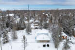 Nestled in a serene winter wonderland, this charming property offers a cozy retreat.