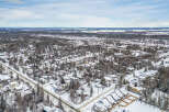 This aerial view showcases a snow-covered residential area, perfect for those seeking a winter wonderland.