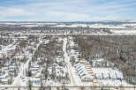 Discover the charm of this snow-covered neighborhood, featuring a variety of homes nestled amidst a winter wonderland.