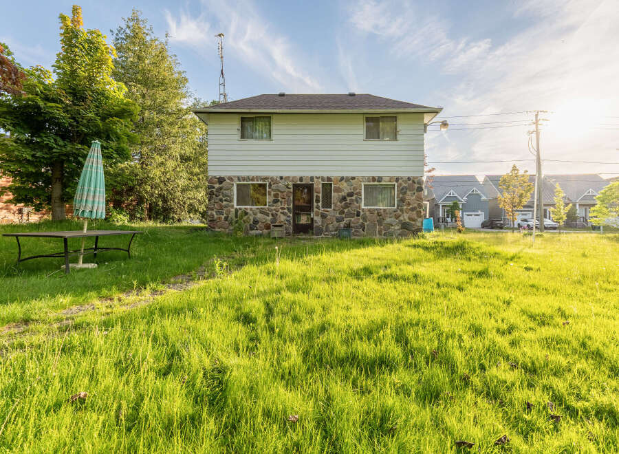 Discover this charming property featuring a unique stone and siding exterior, perfect for a cozy retreat.