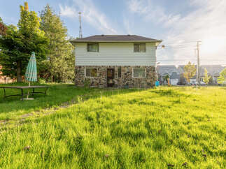 Discover this charming property featuring a unique stone and siding exterior, perfect for a cozy retreat.