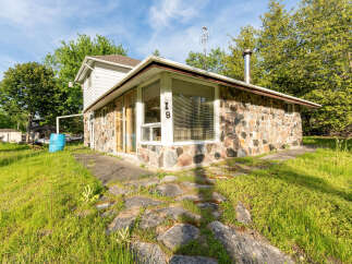 Discover this charming property featuring a unique stone exterior and a welcoming interior.