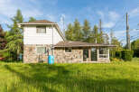 Discover this charming property featuring a unique stone foundation and classic white siding, offering a blend of rustic and modern appeal.