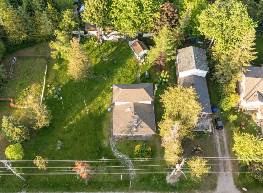 Discover this charming property featuring a well-maintained lawn and mature trees, perfect for outdoor enjoyment.