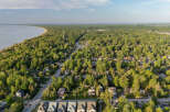 Discover this charming waterfront community nestled amidst lush greenery, offering a serene escape with direct access to the beach.