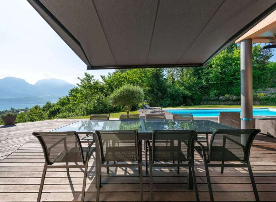 Experience luxury living with this stunning property featuring a spacious outdoor dining area.