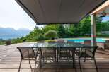 Experience luxury living with this stunning property featuring a spacious outdoor dining area.