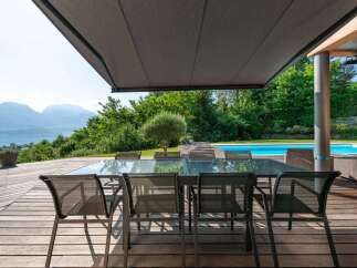 Experience luxury living with this stunning property featuring a spacious outdoor dining area.