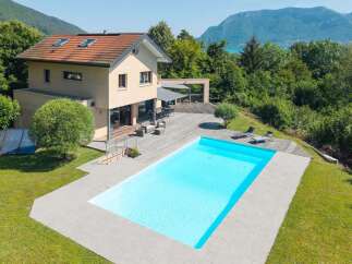 This stunning property boasts a luxurious outdoor pool and a spacious wooden deck, perfect for relaxation and entertaining.